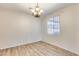The dining room has wood floors, a chandelier, natural light, and neutral walls at 9165 W Mine Trl, Peoria, AZ 85383