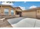 Inviting home exterior with a well-maintained front yard and a two-car garage at 9165 W Mine Trl, Peoria, AZ 85383