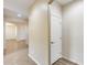 Bright hallway with tiled floor and neutral-colored walls, creating a seamless transition between rooms at 9165 W Mine Trl, Peoria, AZ 85383