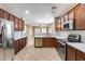 Modern kitchen with stainless steel appliances, tile backsplash, and dark wood cabinetry offers a chef-inspired workspace at 9165 W Mine Trl, Peoria, AZ 85383