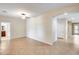 Open living room with tile floors, neutral paint, and archway to additional rooms at 9165 W Mine Trl, Peoria, AZ 85383