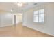 Neutral living room featuring tile flooring, an arched doorway and a front door at 9165 W Mine Trl, Peoria, AZ 85383