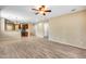 Open-concept living room showcasing hardwood floors, a ceiling fan, and access to the kitchen at 9165 W Mine Trl, Peoria, AZ 85383