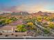 Picturesque aerial shot of a neighborhood showcasing mountain views and lush desert landscaping at 10335 E Morning Star Dr, Scottsdale, AZ 85255