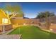 Nighttime backyard featuring a putting green, a hot tub, and a tree illuminated with lights at 10335 E Morning Star Dr, Scottsdale, AZ 85255