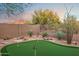 Scenic backyard with a putting green, desert landscaping, and privacy fence at 10335 E Morning Star Dr, Scottsdale, AZ 85255