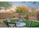 Picturesque backyard with a putting green, a charming table set, and mountain views at 10335 E Morning Star Dr, Scottsdale, AZ 85255