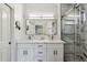 Modern bathroom featuring dual sinks, a large mirror, and a shower with elegant tile work and glass enclosure at 10335 E Morning Star Dr, Scottsdale, AZ 85255