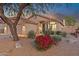 Charming single-story home featuring desert landscaping, a tile roof, and a welcoming facade at dusk at 10335 E Morning Star Dr, Scottsdale, AZ 85255