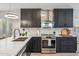 Modern kitchen features dark cabinets, marble countertops, stainless steel appliances, and a stylish backsplash at 10335 E Morning Star Dr, Scottsdale, AZ 85255