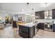 Modern kitchen with stainless steel appliances, dark cabinetry, marble countertops, and an island with seating at 10335 E Morning Star Dr, Scottsdale, AZ 85255