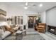 Bright living room featuring modern furnishings, a cozy fireplace, and access to the outdoor patio at 10335 E Morning Star Dr, Scottsdale, AZ 85255
