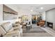 Cozy living room with a fireplace, stylish furnishings, and a sliding glass door to the patio at 10335 E Morning Star Dr, Scottsdale, AZ 85255