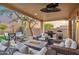 Inviting covered outdoor patio with comfortable seating, a fire pit, and a built-in grill at 10335 E Morning Star Dr, Scottsdale, AZ 85255