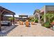 Private backyard patio area featuring multiple pergolas, outdoor seating, and lush landscaping at 11013 E Decatur St, Mesa, AZ 85207
