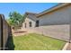 Well maintained backyard with lush green artificial grass and mature landscaping, providing a serene outdoor space at 11013 E Decatur St, Mesa, AZ 85207