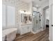 Bathroom with soaking tub, vanity, and glass shower at 11013 E Decatur St, Mesa, AZ 85207