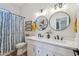 Bathroom with double sink vanity, modern fixtures, and blue patterned shower curtain at 11013 E Decatur St, Mesa, AZ 85207