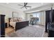Spacious bedroom with large bed, wood floors, ceiling fan and view of the backyard at 11013 E Decatur St, Mesa, AZ 85207