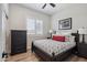 Cozy bedroom features a comfortable bed, dresser, and plantation shutters for a relaxing ambiance at 11013 E Decatur St, Mesa, AZ 85207