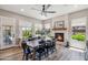 Dining room featuring fireplace, wood table and chairs, and large windows at 11013 E Decatur St, Mesa, AZ 85207
