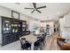 Open-concept dining room features decorative hutch, wood table, seating for eight, and an open view to the kitchen at 11013 E Decatur St, Mesa, AZ 85207
