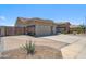 Spacious driveway and three-car garage complemented by a well-kept yard and mature desert landscaping at 11013 E Decatur St, Mesa, AZ 85207
