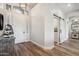 Bright and airy foyer showcasing modern accents, tiled floors, and entry to the laundry room at 11013 E Decatur St, Mesa, AZ 85207