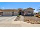 Charming single-story home with a well-manicured front yard, three-car garage, and inviting curb appeal at 11013 E Decatur St, Mesa, AZ 85207