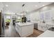 Spacious white kitchen with a large center island, stainless steel appliances, and ample counter space at 11013 E Decatur St, Mesa, AZ 85207