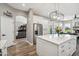 Bright kitchen features an island, stainless steel appliances, and wood flooring at 11013 E Decatur St, Mesa, AZ 85207