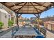 Inviting outdoor dining area under a pergola with BBQ, seating, and relaxing backyard views at 11013 E Decatur St, Mesa, AZ 85207