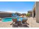 Inviting pool area with lounge chairs, water feature, and lush landscaping at 11013 E Decatur St, Mesa, AZ 85207