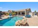 Beautiful backyard featuring a sparkling pool, patio, and comfortable lounge seating at 11013 E Decatur St, Mesa, AZ 85207