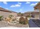 Beautiful backyard with a tranquil water feature, desert landscaping, and a cozy patio area at 11040 E Nichols Ave, Mesa, AZ 85209