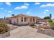 Serene backyard featuring a tiled patio, desert landscaping, and a tranquil water feature at 11040 E Nichols Ave, Mesa, AZ 85209