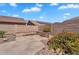 Private backyard showcasing a tiled patio and desert landscaping, with block wall ensuring seclusion at 11040 E Nichols Ave, Mesa, AZ 85209