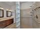 Modern bathroom features double sink vanity, tile floor, and glass block partition at 11040 E Nichols Ave, Mesa, AZ 85209