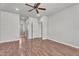 Bedroom with wood-look flooring and ceiling fan, looking into hall and bathroom at 11040 E Nichols Ave, Mesa, AZ 85209