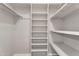 Spacious walk-in closet with custom shelving and organization system at 11040 E Nichols Ave, Mesa, AZ 85209