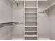 Walk-in closet features built-in shelving and clothing racks at 11040 E Nichols Ave, Mesa, AZ 85209