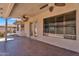 Inviting covered patio featuring tiled flooring, ceiling fans, and a view of the landscaped backyard at 11040 E Nichols Ave, Mesa, AZ 85209