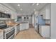 Well-equipped kitchen with tile floors, stainless steel appliances, and white cabinets at 11040 E Nichols Ave, Mesa, AZ 85209