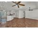 Bright open-concept living room with hardwood floors connects to the kitchen at 11040 E Nichols Ave, Mesa, AZ 85209