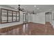 Bright living room boasts hardwood floors, ceiling fans, and plantation shutters at 11040 E Nichols Ave, Mesa, AZ 85209
