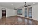 Open-concept living room features hardwood floors, ceiling fans, and bright lighting at 11040 E Nichols Ave, Mesa, AZ 85209