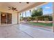 Relaxing covered patio overlooking a beautifully landscaped backyard with lush greenery and a well manicured lawn at 12820 W La Vina Dr, Sun City West, AZ 85375