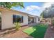 Private backyard with low-maintenance landscaping and an artificial turf area creates an inviting outdoor retreat at 12820 W La Vina Dr, Sun City West, AZ 85375