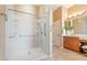 Large walk-in shower features dual shower heads and easy access, with a vanity nearby at 12820 W La Vina Dr, Sun City West, AZ 85375