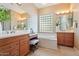 Well-lit bathroom with double sinks, soaking tub, and a window allowing natural light at 12820 W La Vina Dr, Sun City West, AZ 85375